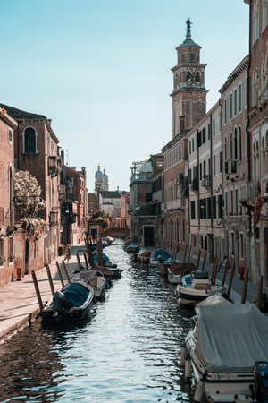 Vertical canal view with distant bell towerの写真素材