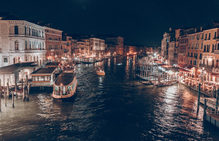 Night cityscape of canal with lights and boatsの写真素材