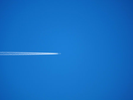 airplane in the blue sky, closeup of photo with soft focusの写真素材