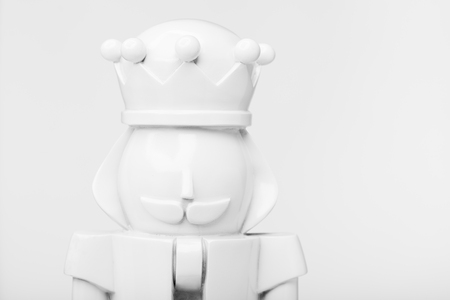 Closeup of a white christmas nutcracker against white bacground