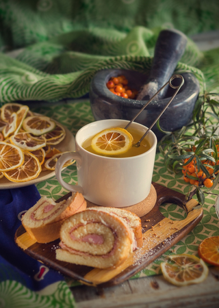 cup of tea, a biscuit, berries and dried fruits on the table. Vintage styleの写真素材