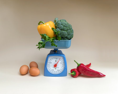 Vegetables on a kitchen scale and eggs on a light backgroundの写真素材