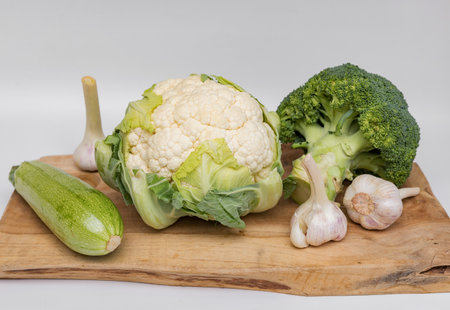 Cauliflower, broccoli, garlic and zucchini on white backgroundの写真素材