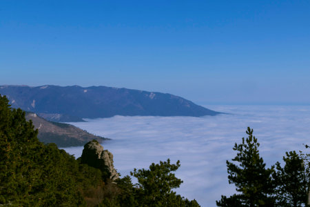 fog high in the Crimean mountains like a duvet, top view, blue sky and clean air