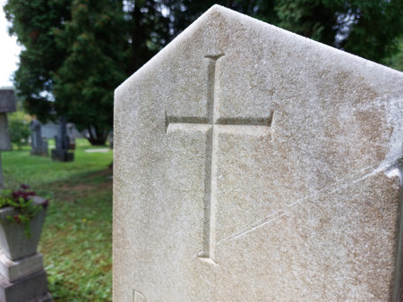 catholic cross on light gray stone at old cemetery in Ptuj. Sloveniaの写真素材