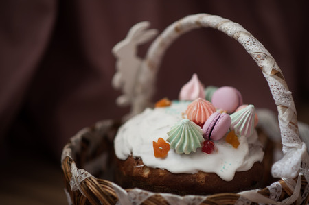 Easter cake lies in a festive Easter basket, decorated with macaroni