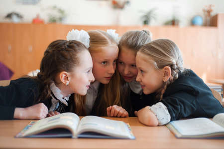 girls at a school desk communicate with each otherのeditorial素材