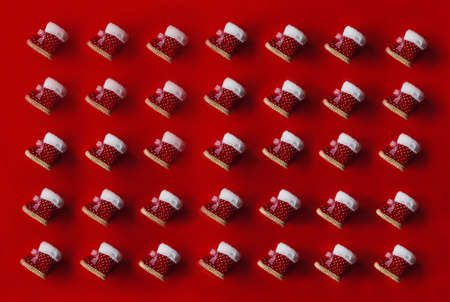 childrens christmas boots lie on a red background pattern top viewの写真素材