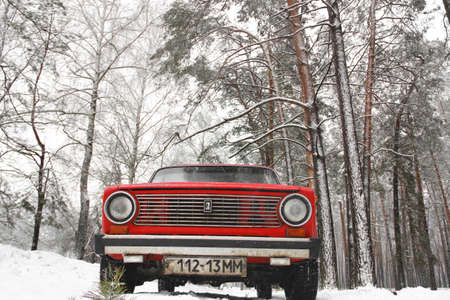 Chernihiv, Ukraine - January 20, 2020: Old red VAZ 21011 car in the winter forestのeditorial素材