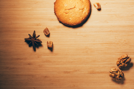 Top view of round crunchy sweet biscuits with candied fruit and nuts, on textured wooden backgroundの写真素材