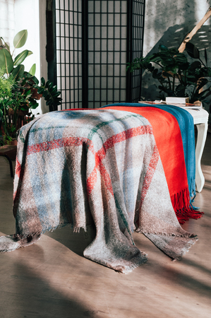 Colorful textile scarves and accessories, beautifully displayed for customers attraction in show-room. Fashionable, trendy, seasonal everyday essential item. Image for catalogue, booklet, market placeの写真素材