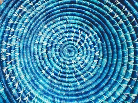 Blue wicker round dish. Clouse up image. Beautiful colorful texture. Wallpaper, banner, background. Countryside, healthy life, natural, simplicity, organic conceptの写真素材