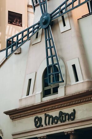 El Molino bar sign in downtown of Barcelona, Spain - September 11, 2018. Big windmill on the facade...