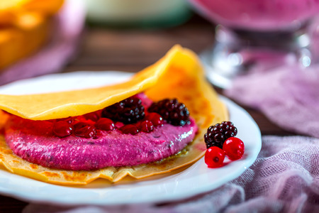 Tasty Pancake on white plate. Pancake with curd cream and berries.  Selective focusの写真素材