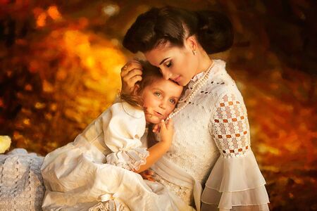 Mother and little daughter playing together in a parkの写真素材