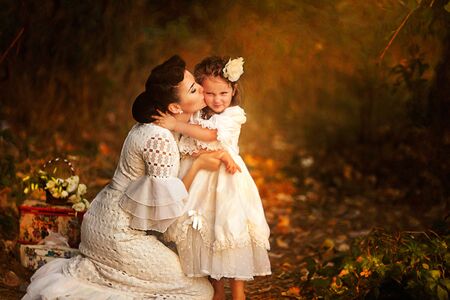 Mother and little daughter playing together in a parkの写真素材