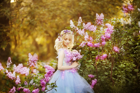 Young girl in beautiful wreath of lilac flowersの写真素材