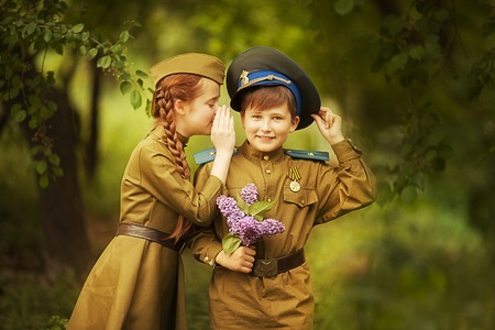 Boy with a girl in military uniform.day of victory