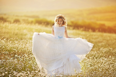 beautiful blonde in a chamomile fieldの写真素材