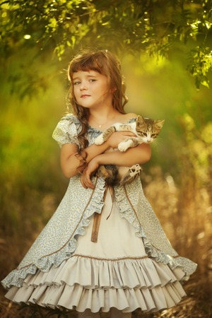 Adorable little girl in blooming apple tree