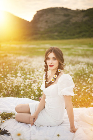 Beautiful girl is relaxing lying on the grass in the gardenの写真素材