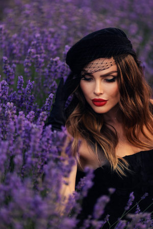 Beautiful girl is wearing fashion dress at field of lavender. girl walking through a lavender fieldの写真素材
