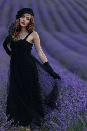 Beautiful girl is wearing fashion dress at field of lavender. Provenceの写真素材