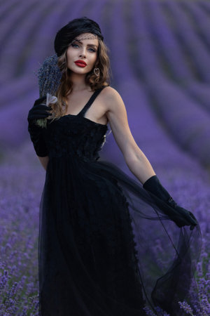 Beautiful girl is wearing fashion dress at field of lavender. Provence