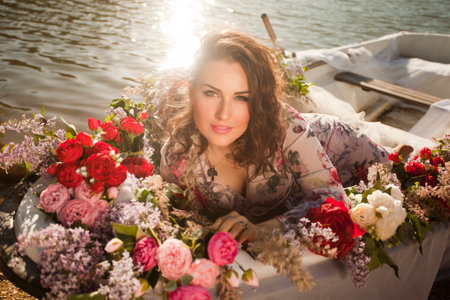 Cheerful romantic girl in a hat is riding boat. Summer mood lifestyle. Rest on the water on the...