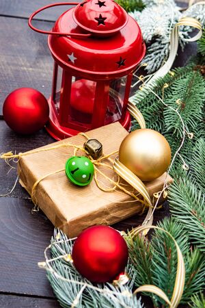 Christmas gift concept with bright ribbon and fir tree on wooden background with copy spaceの写真素材