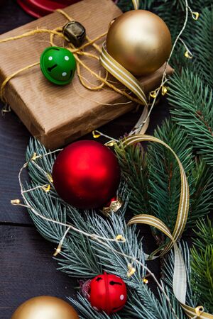 Christmas gift concept with bright ribbon and fir tree on wooden background with copy spaceの写真素材