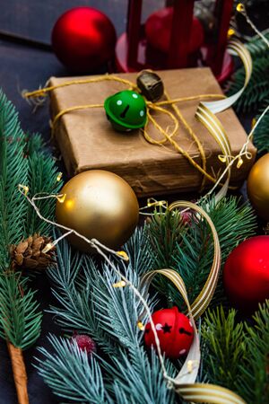 Christmas gift concept with bright ribbon and fir tree on wooden background with copy spaceの写真素材