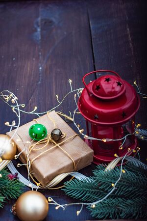 Christmas gift concept with bright ribbon and fir tree on wooden background with copy spaceの写真素材