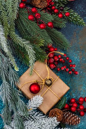 Christmas gift concept with bright ribbon and fir tree on wooden background with copy spaceの写真素材