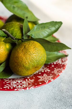 Christmas card concept with organic tangerines on stone background with copy spaceの写真素材