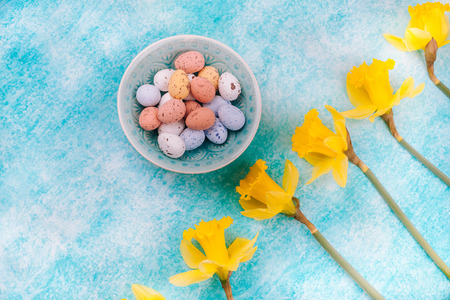 Easter chocolate quail eggs on light blue background. The concept of the holiday of Easter