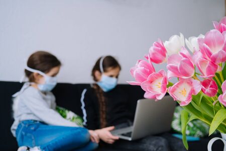 Online education, distance learning, homeschooling. Children studying homework during online lesson at home in tablet of laptop and holding videocall. Social distance on quarantine. Self-isolationの写真素材