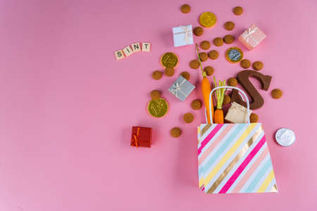 Dutch holiday Sinterklaas Greeting Card. St Nicholas Day background with traditional food - pepernoten, chocolate letter, gift, carrots for horse. Concept for party in Saint Nicolas day five decemberの写真素材
