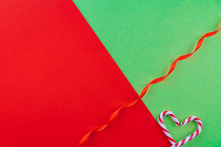 Holiday minimalist decorations. Christmas composition. Present box, Xmas candy canes, red festive...