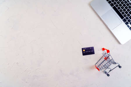 Top view of laptop, black friday promotion sale words on lightbox, gift boxes, laptop, shopping cart...