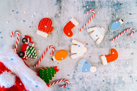 Christmas and new year gingerbread cookies on table. sweets tasty biscuits glazed sugar icing decoration. Winter holidays, New Year eve party or xmas concept. Seasonal packaging and attributes.の写真素材