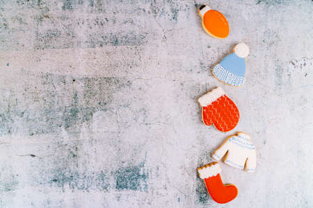 Christmas and new year gingerbread cookies on table. sweets tasty biscuits glazed sugar icing decoration. Winter holidays, New Year eve party or xmas concept. Seasonal packaging and attributes.の写真素材