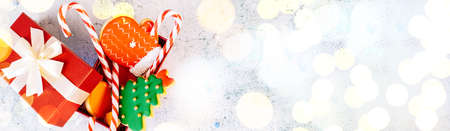 Christmas and new year gingerbread cookies on table. sweets tasty biscuits glazed sugar icing decoration. Winter holidays, New Year eve party or xmas concept. Seasonal packaging and attributes.の写真素材