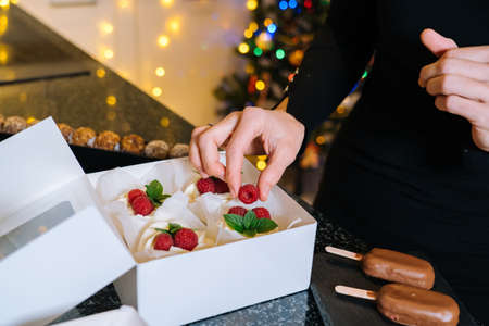 Homemade Christmas baked assorted sweets. Happy New Year and Merry Christmas background. Winter decorations over dark background defocus xmas tree light. Festive decoration. Selective Focus.の写真素材