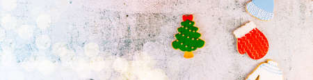 Christmas and new year banner. gingerbread cookies on table. sweets tasty biscuits glazed sugar icing decoration. Winter holidays, New Year eve party or xmas concept. Seasonal packaging and attributesの写真素材