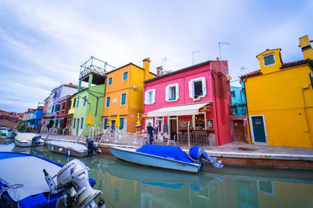View of streets with colorful houses in Burano along canal. Typical tourist place - burano island in the Venetian lagoon Italy. Beautiful water canals and colorful architecture. Burano. Italyのeditorial素材