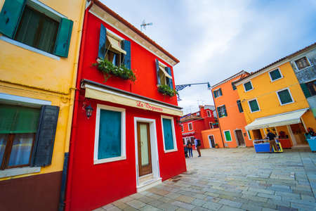 View of streets with colorful houses in Burano along canal. Typical tourist place - burano island in the Venetian lagoon Italy. Beautiful water canals and colorful architecture. Burano. Italyのeditorial素材