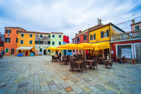View of streets with colorful houses in Burano along canal. Typical tourist place - burano island in the Venetian lagoon Italy. Beautiful water canals and colorful architecture. Burano. Italyのeditorial素材