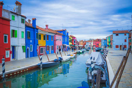 View of streets with colorful houses in Burano along canal. Typical tourist place - burano island in the Venetian lagoon Italy. Beautiful water canals and colorful architecture. Burano. Italyのeditorial素材