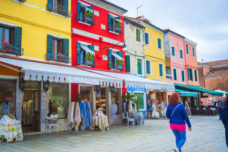 View of streets with colorful houses in Burano along canal. Typical tourist place - burano island in the Venetian lagoon Italy. Beautiful water canals and colorful architecture. Burano. Italyのeditorial素材